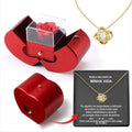 Red apple-shaped jewelry box with eternal soap flower rose and silver necklace inside