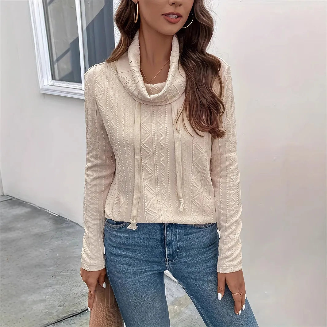 Apricot coloured pullover sweater with a drawstring hood and long sleeves laid flat.
