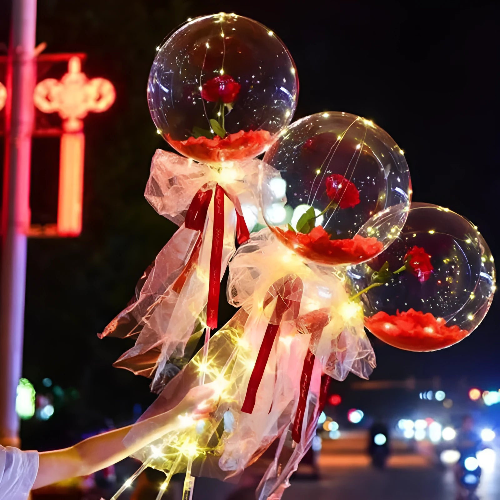 Transparent LED luminous balloon with artificial rose and built-in light, shown as a DIY bouquet kit.
