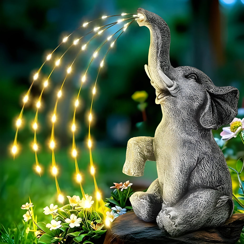 Outdoor resin elephant garden statue with integrated LED light strip.