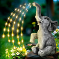 Outdoor resin elephant garden statue with integrated LED light strip.