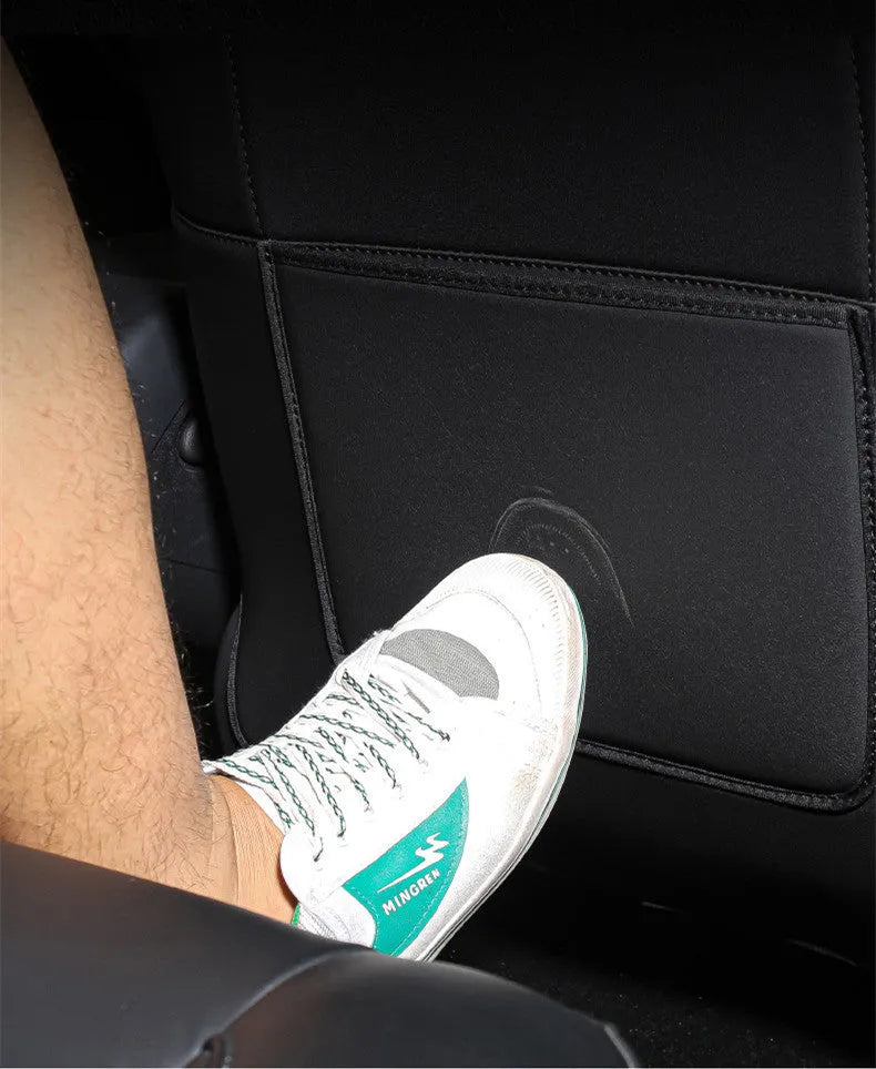 Set of two black leather anti kick pads for car rear seats, shown with dimensions.