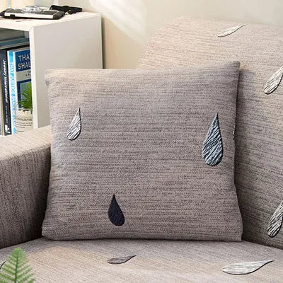 Geometric print polyester sofa slipcover stretched over sofa with matching pillowcase