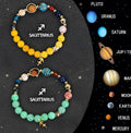 Two natural stone beaded bracelets for zodiac signs on a neutral background.