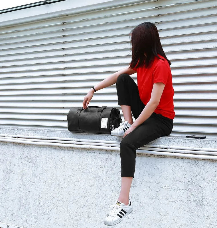 Black waterproof sports bag with side shoe compartments showing diagonal straps and two size options