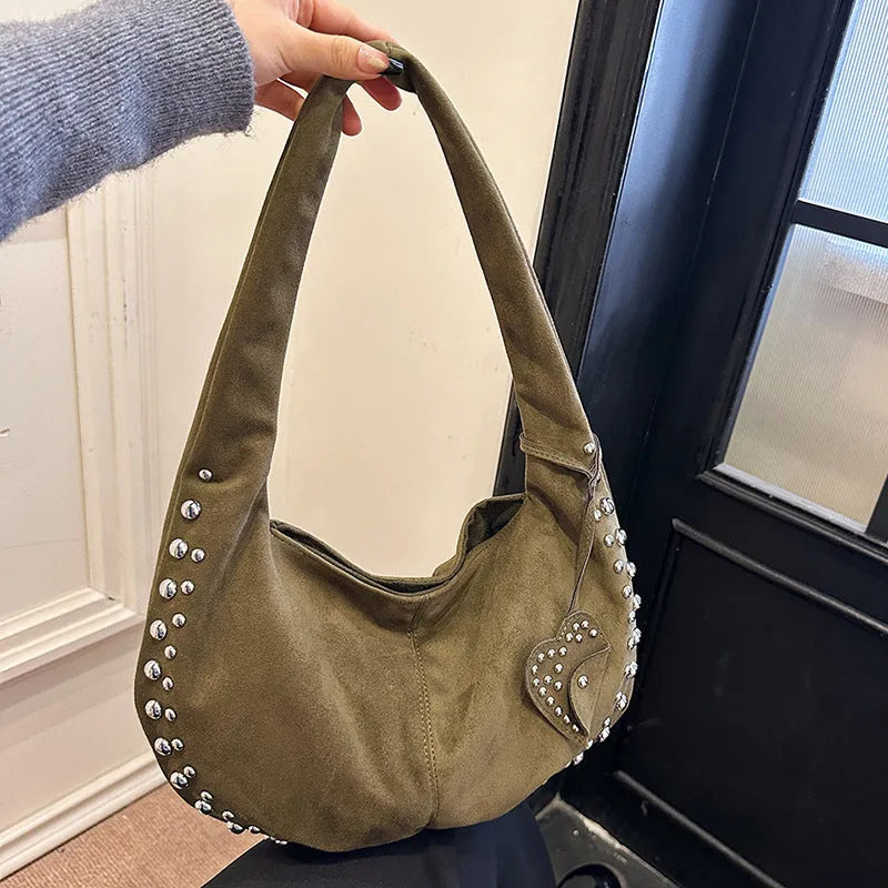 A soft plush underarm tote handbag in a retro style, shown in a colour option.