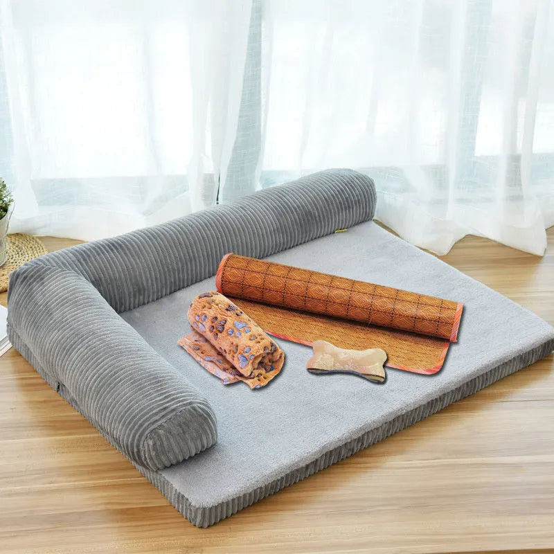 Grey corduroy dog sofa bed with raised sides on a wooden floor, showing its non-slip base.