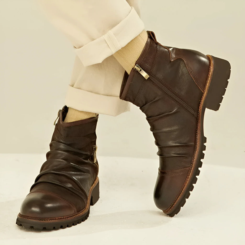Men's black side-zip cowboy boots with embossed texture and a mid-height horseshoe rubber heel.