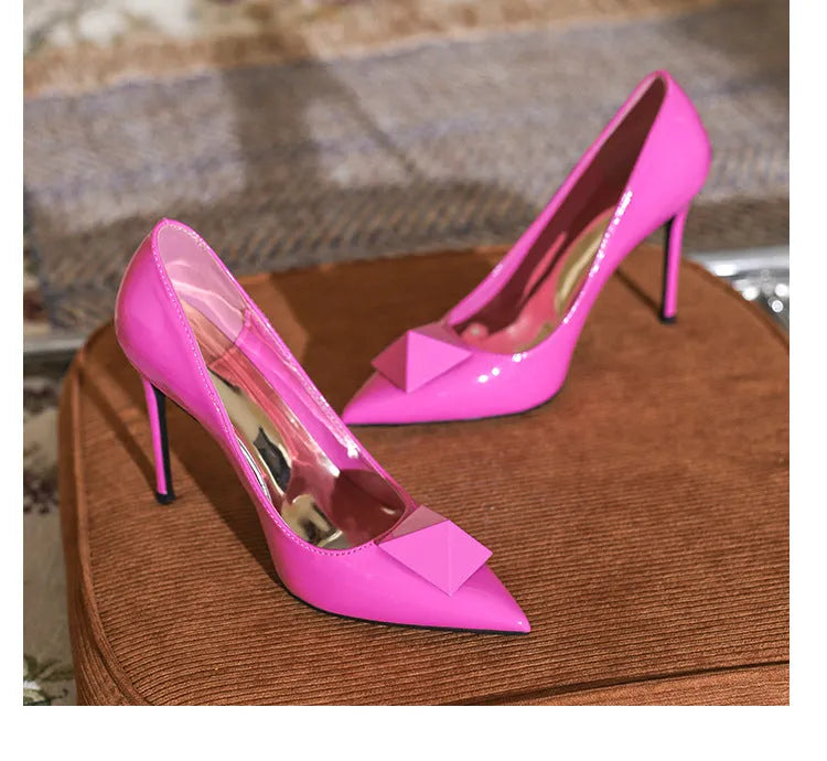 Pink patent leather women's pointed toe stiletto high heels with buckle and rivet detail