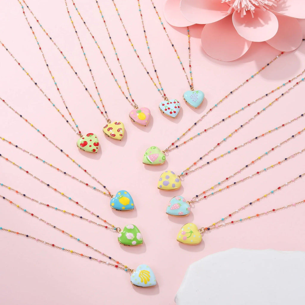 Stainless steel fruit pendant necklace with gold plating showing heart and fruit charm designs on adjustable chain