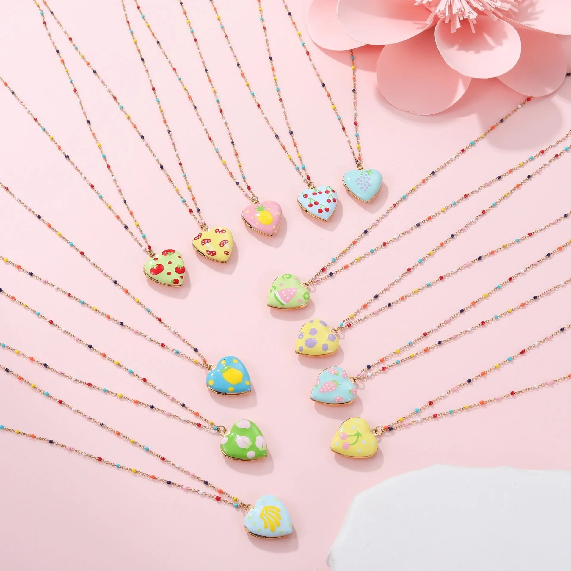 Stainless steel fruit pendant necklace with gold plating showing heart and fruit charm designs on adjustable chain