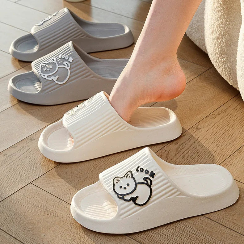 Green cat design thick EVA platform slippers on a wooden floor