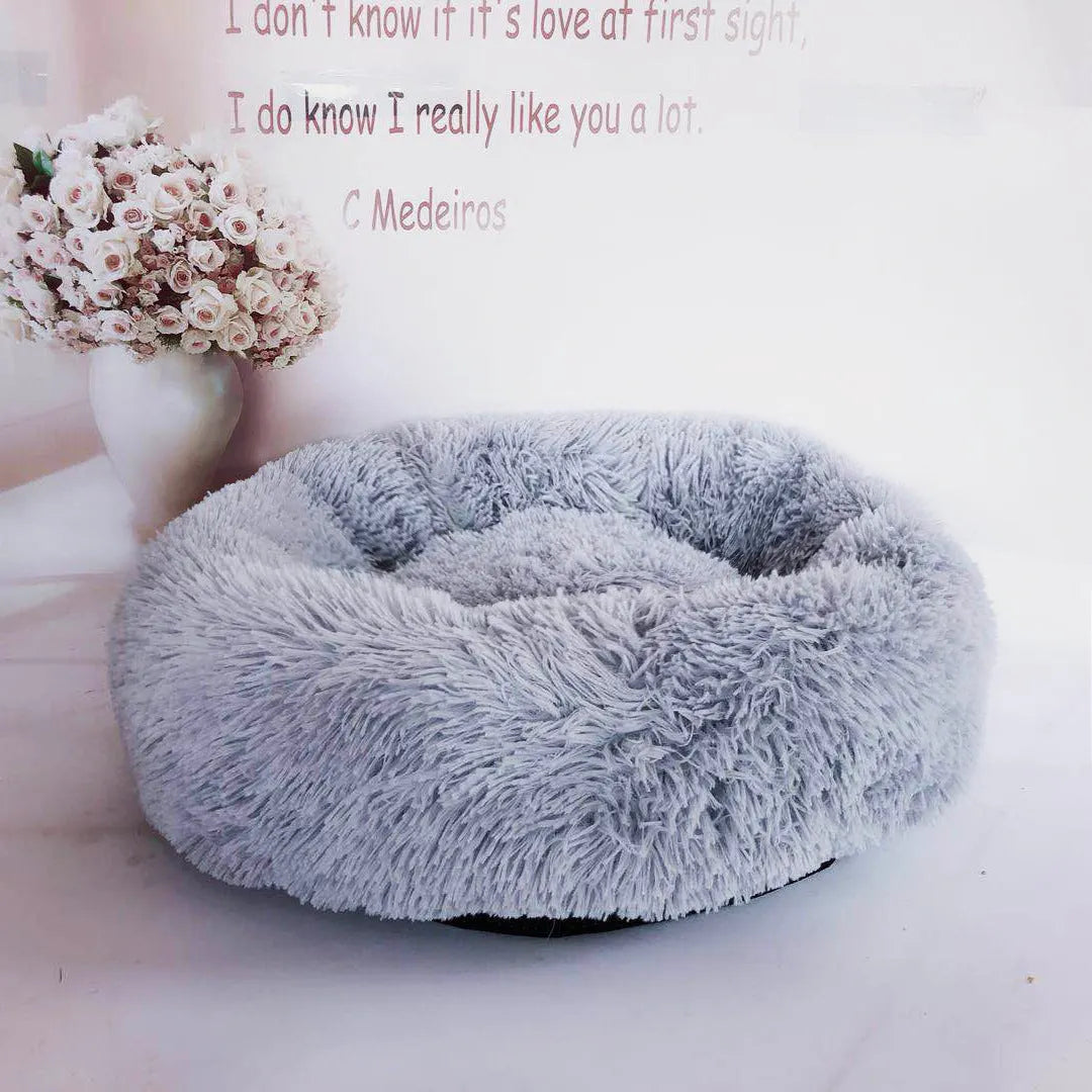 Plush pet nest in apricot colour on floor, soft cloth circular dog bed 40cm diameter indoor use