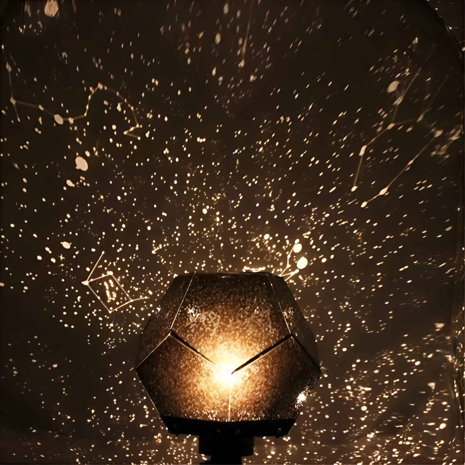 LED starry sky projector night light showing constellation projection on a bedroom ceiling.