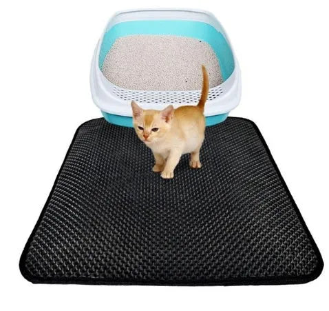 Double layer EVA cat litter mat in black with textured surface, placed under a litter box to trap debris
