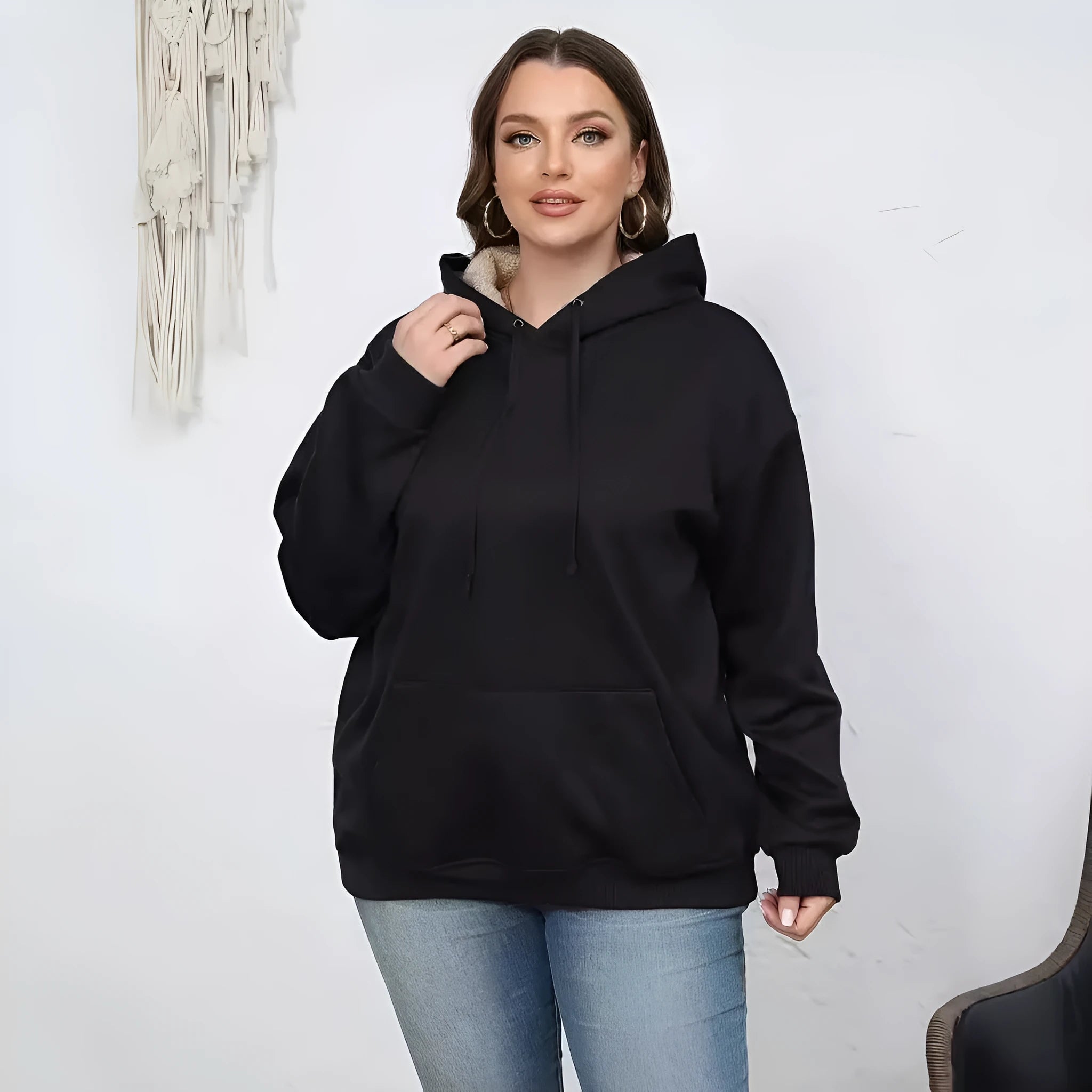 Women's loose grey hooded sweater with a 3D textured pattern on the front.