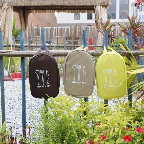 12-piece stainless steel picnic utensil set inside a khaki portable storage bag for outdoor dining.