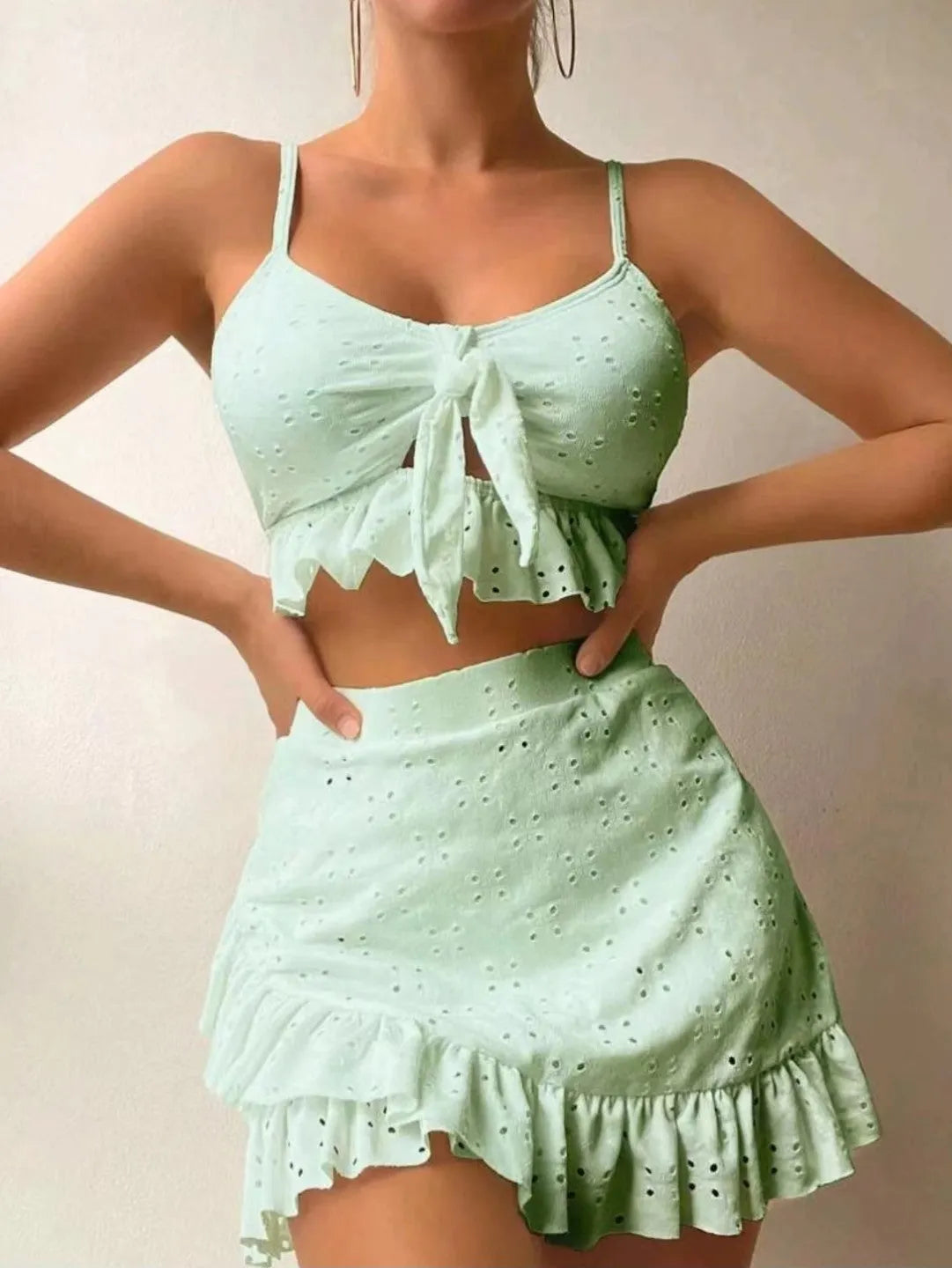 Women's solid colour three-piece skirt bikini swimsuit in polyester fabric.