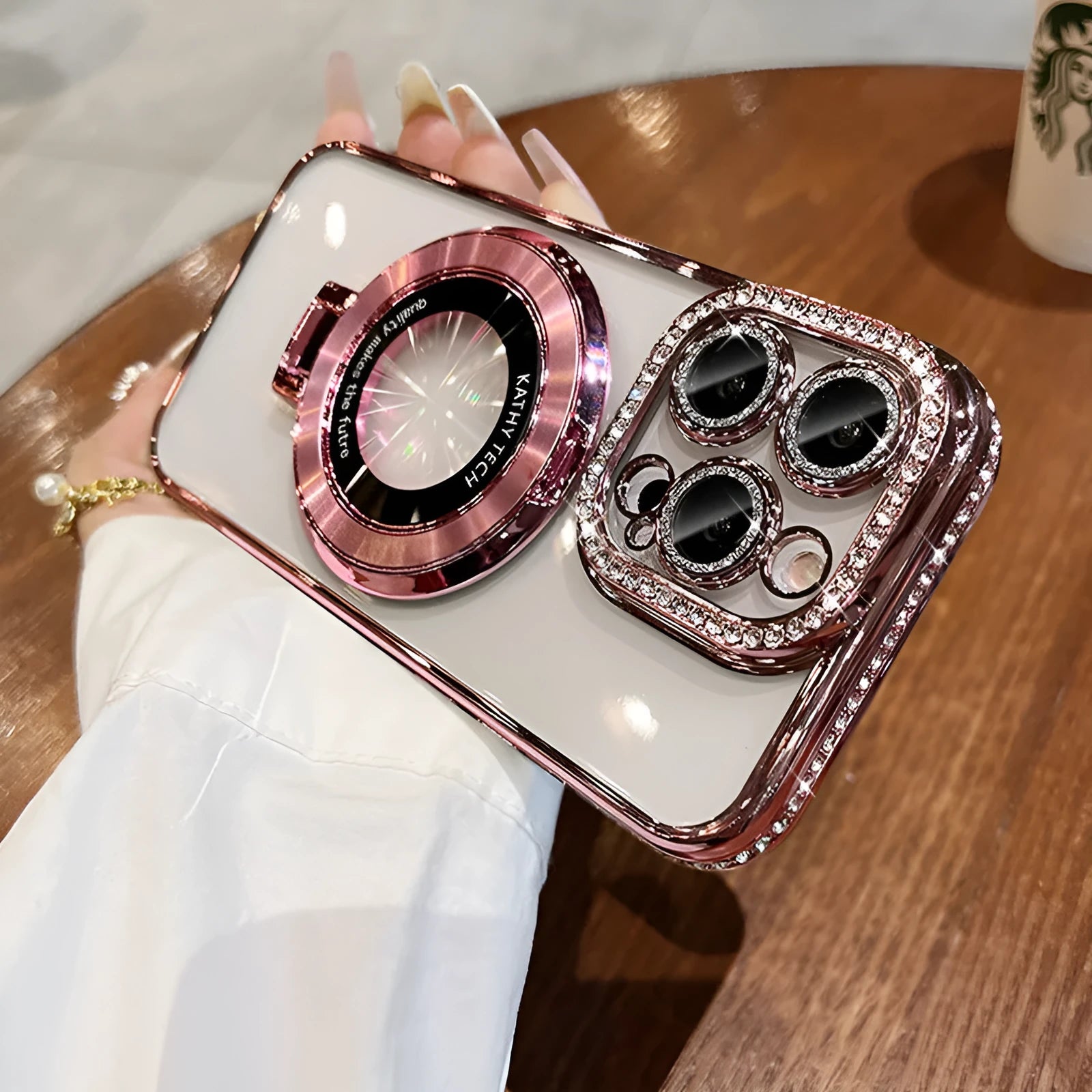 Transparent silicone iPhone case with rhinestone frame and built-in magnetic bracket in pink colour.