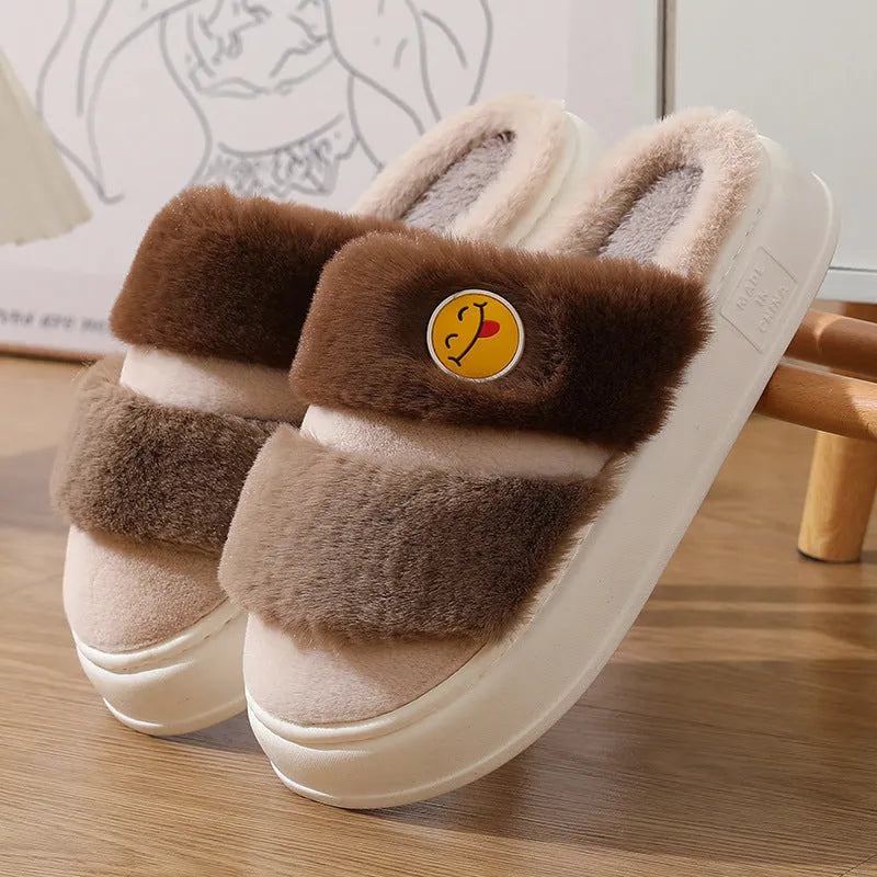 Pink and green thermal cotton slippers with plush upper and non-slip sole.