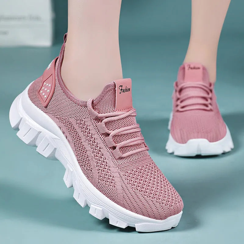 Women's white Flyknit running sneakers with thick PVC sole and lace-up front