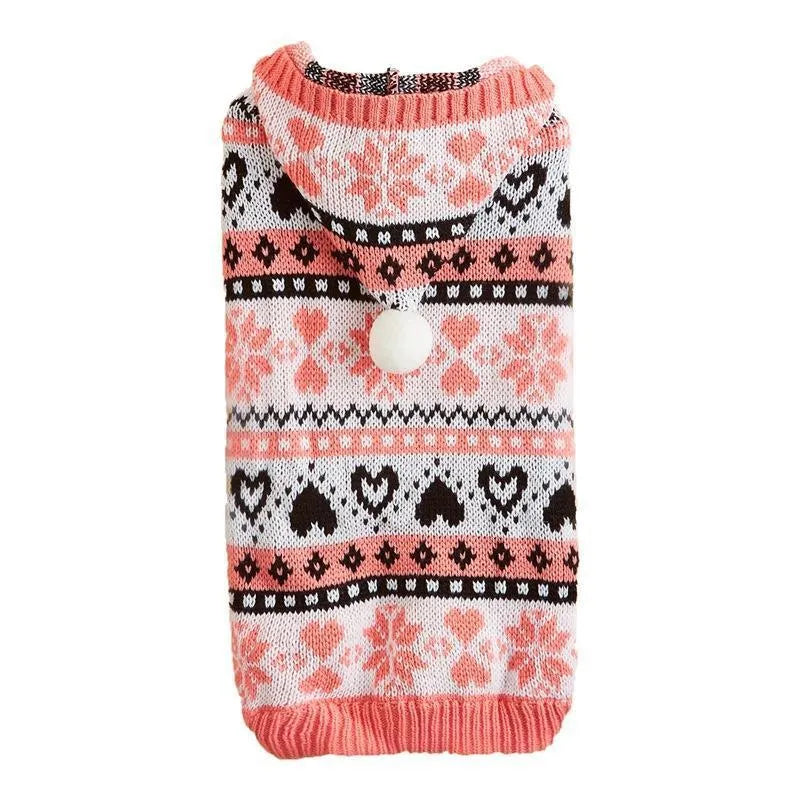 Pink knitted dog jumper with snowflake, love heart, and striped camouflage pattern on a small white dog.