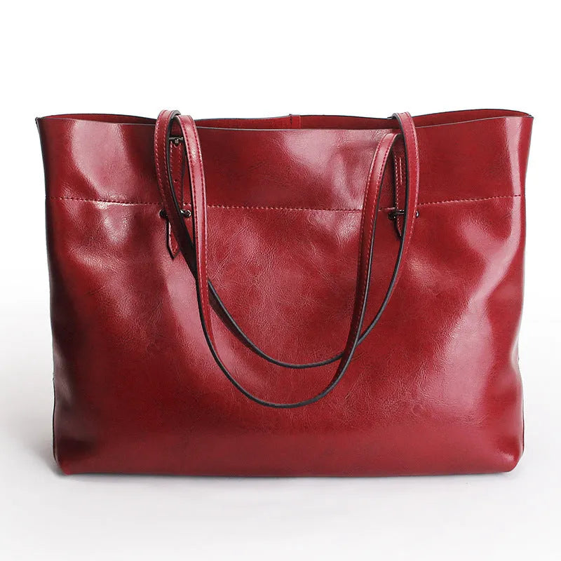 Women's wax cowhide leather handbag with horizontal silhouette and cross-body strap