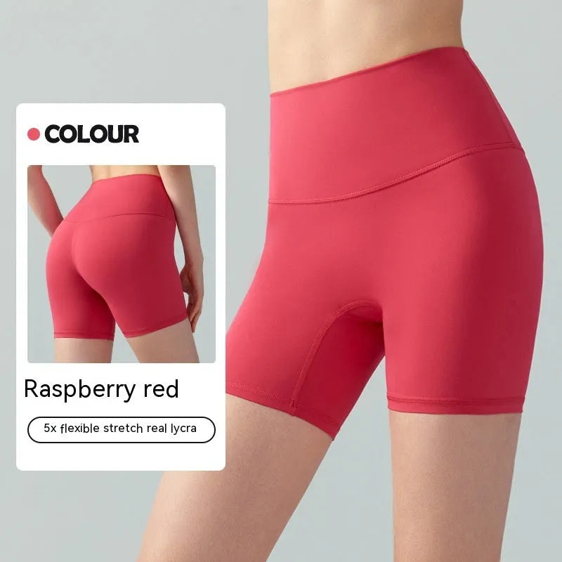 Women's high-waisted Lycra yoga shorts in leaf green, showing anti-exposure construction and short length.