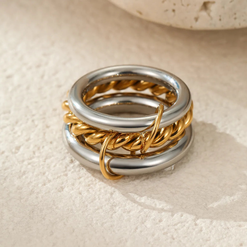 Stacked colour matching stainless steel ring set with 18K gold plating and exaggerated profile