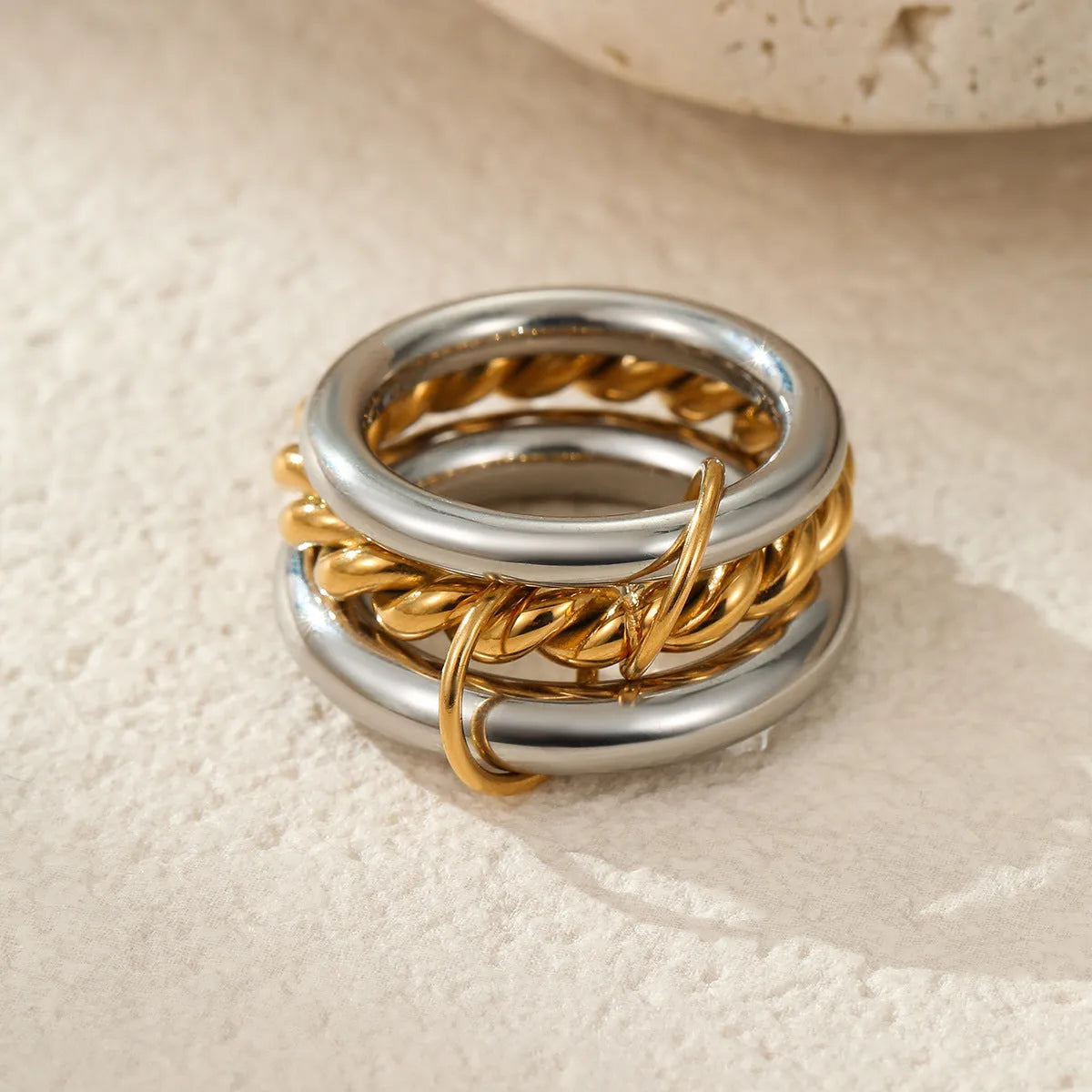 Stacked colour matching stainless steel ring set with 18K gold plating and exaggerated profile