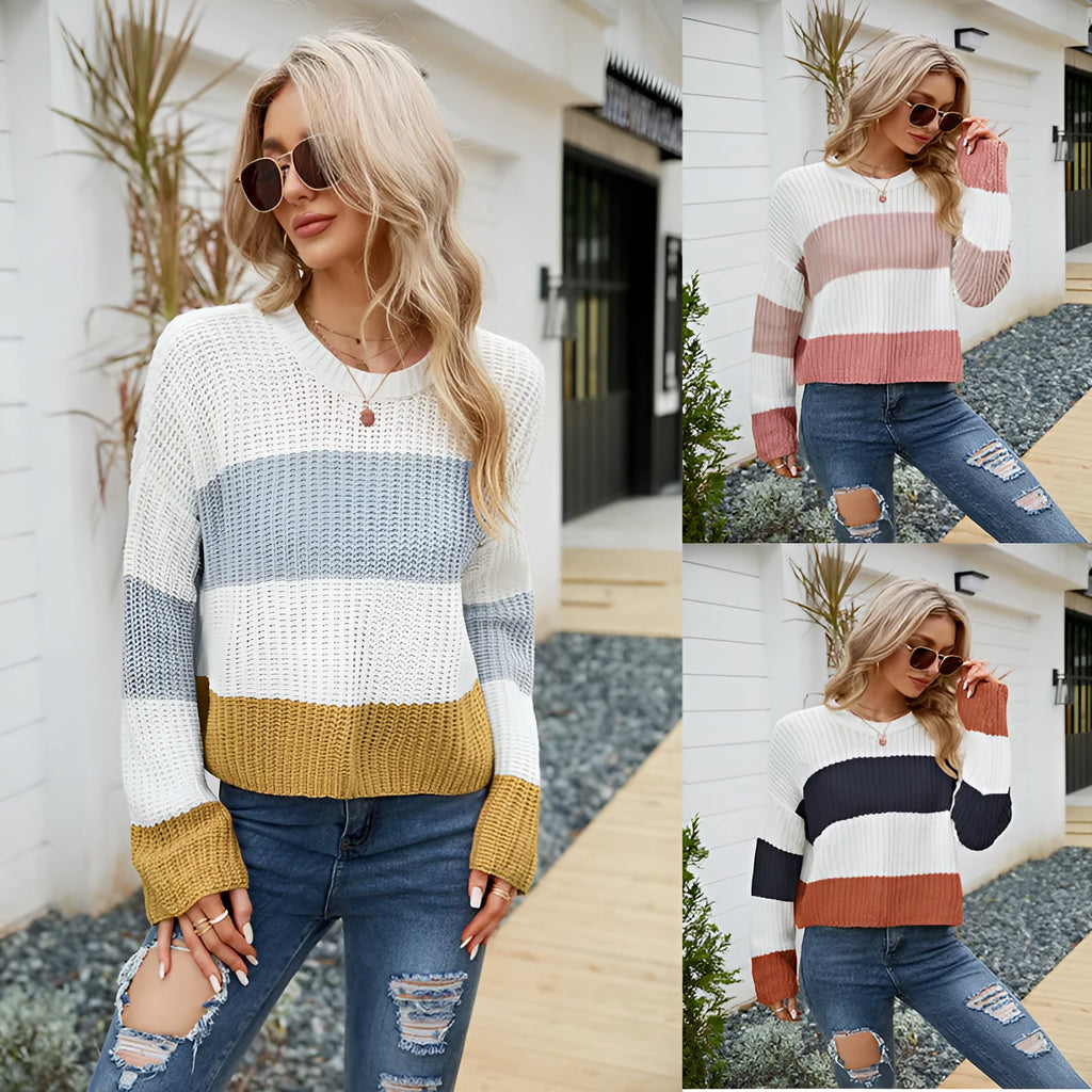 Women's short striped loose pullover sweater in acrylic knit on a hanger.