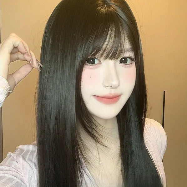 Dark brown long straight synthetic wig with a fringe on a wig head stand.