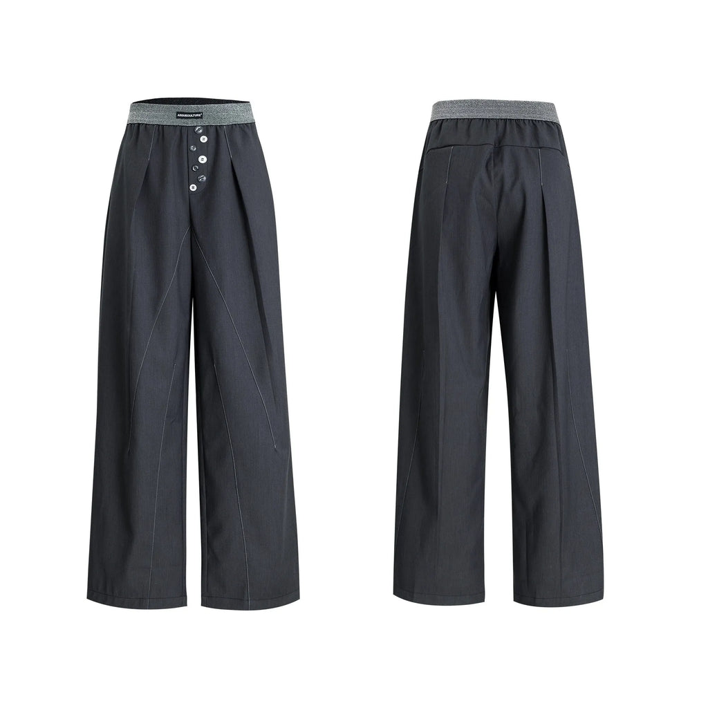 Black straight-leg high-waist trousers with button detail on smart casual model
