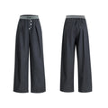 Black straight-leg high-waist trousers with button detail on smart casual model