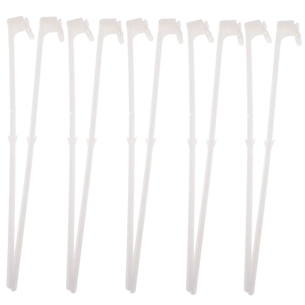 Ten white plastic car window flag pole holder clips on a flat surface.