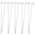 Ten white plastic car window flag pole holder clips on a flat surface.