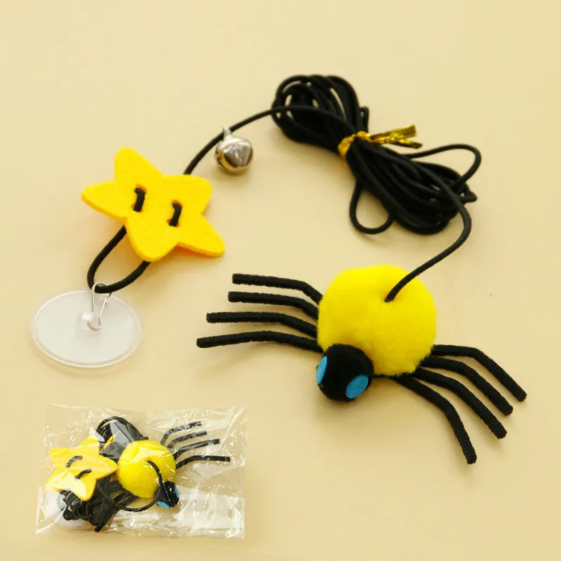 Red and yellow hanging cat toy with elastic rope, feather, bell, and spider elements for door mounting