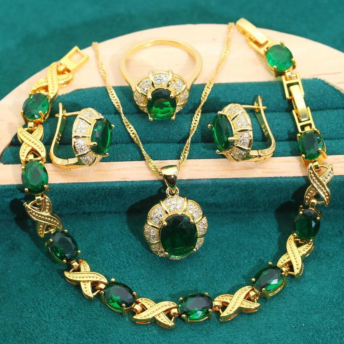 18k gold plated zircon jewellery set showing necklace, earrings, bracelet, and ring with sparkling cubic zirconia stones