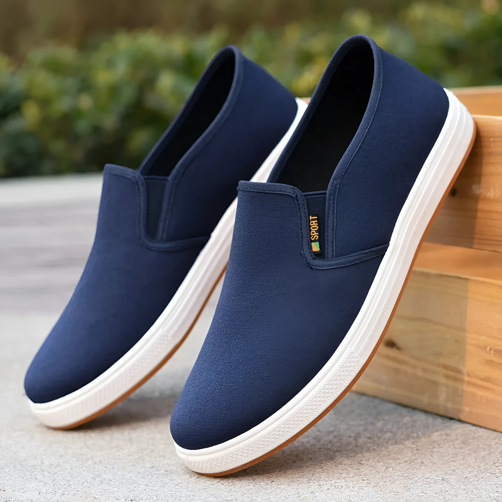 Men's black and blue canvas slip-on shoes with round toe design and composite soles