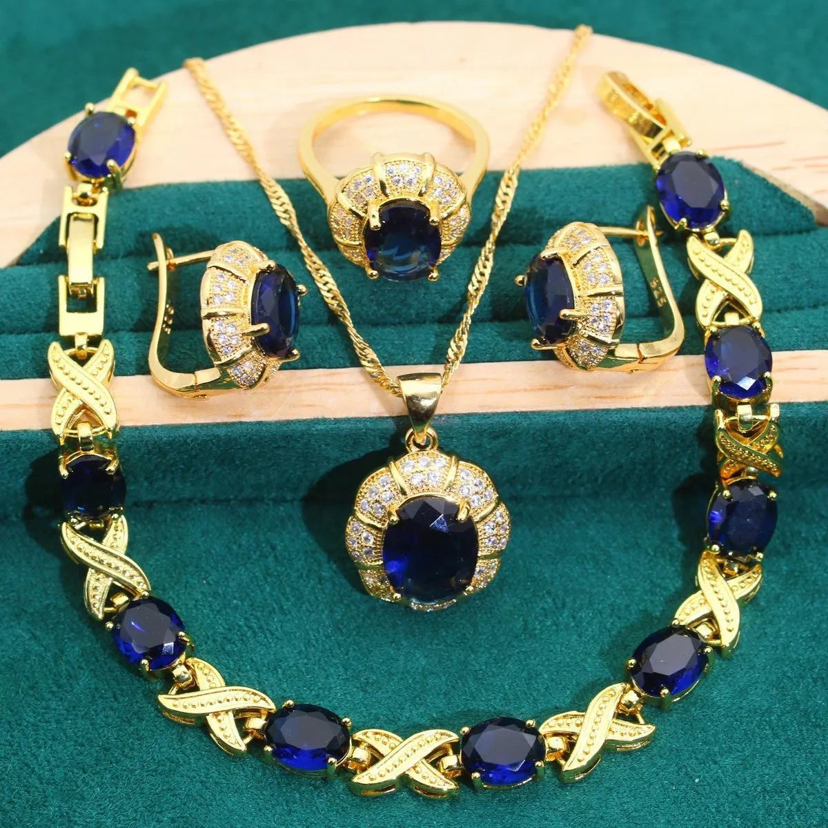 18k gold plated zircon jewellery set showing necklace, earrings, bracelet, and ring with sparkling cubic zirconia stones