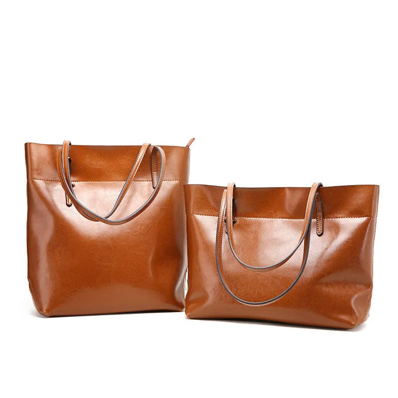Women's wax cowhide leather handbag with horizontal silhouette and cross-body strap