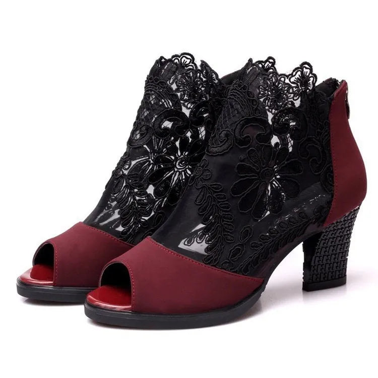 Black lace gladiator sandals for women with a square high heel and peep toe, showing zip closure.