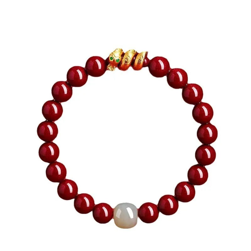 Handmade Chinese snake year bracelet with red cinnabar beads on a black cord.