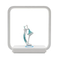 Atmosphere table lamp with wireless phone charger in blue light setting on a bedside table, 25cm tall