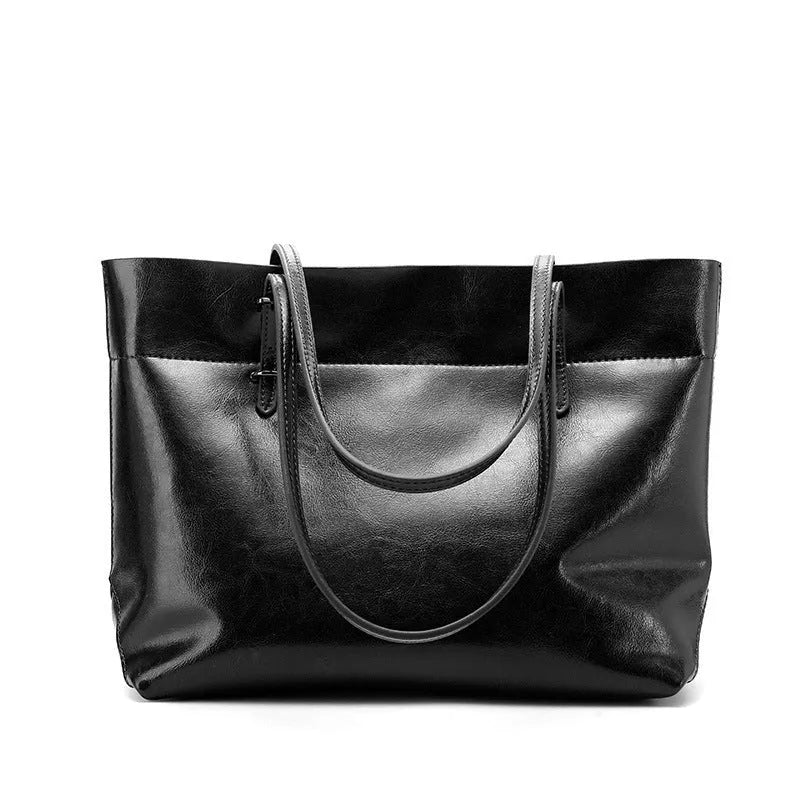 Women's wax cowhide leather handbag with horizontal silhouette and cross-body strap