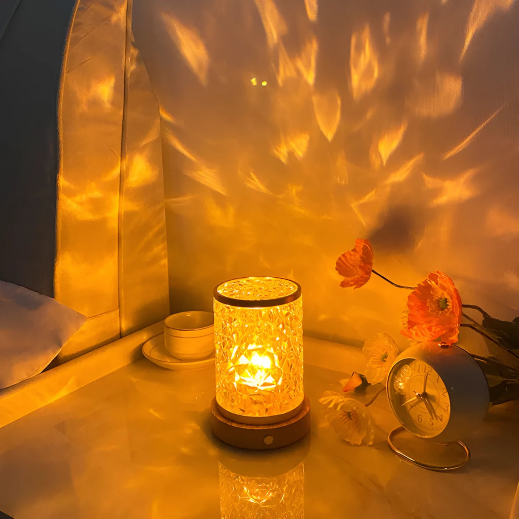 Modern rotating water ripple night light with acrylic body and solid wood base on a surface.