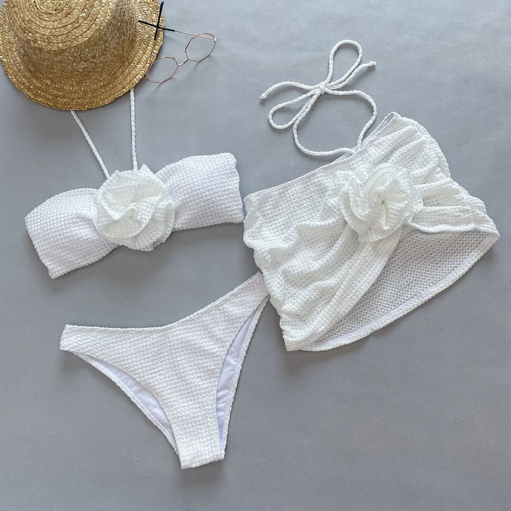 Women's white and purple 3D flower split bikini three-piece swimsuit set on a mannequin