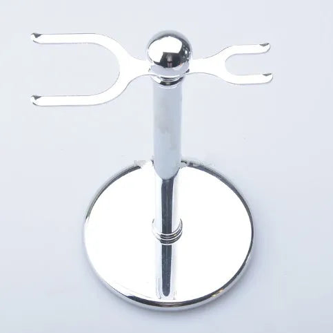 CSB men's shaving kit with chrome stand holding a double edge razor and badger hair brush, plus soap bowl and blades.