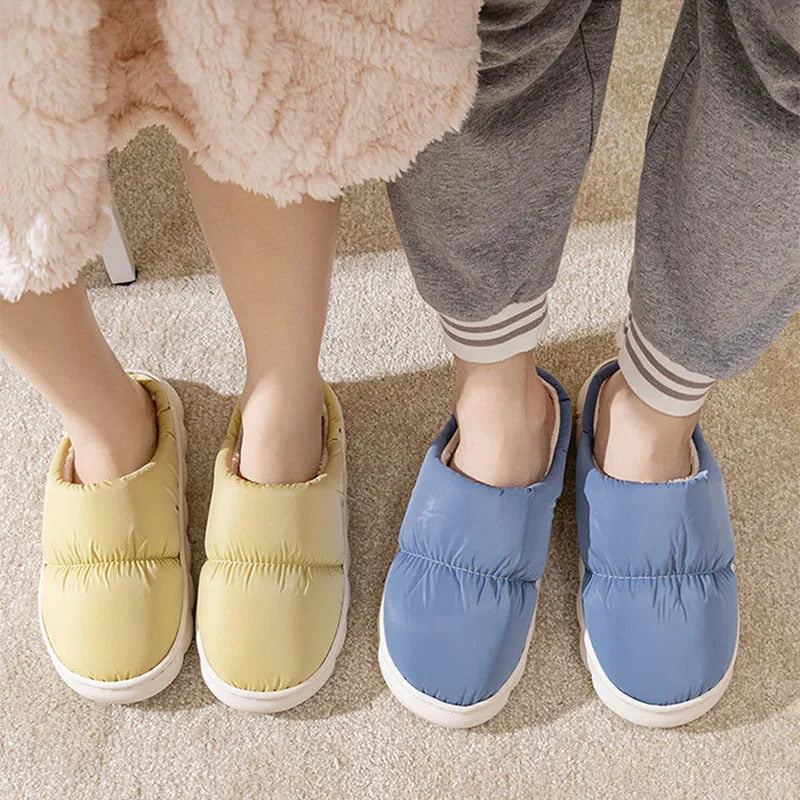 Pair of down cotton indoor slippers with artificial leather upper and thick rubber sole.