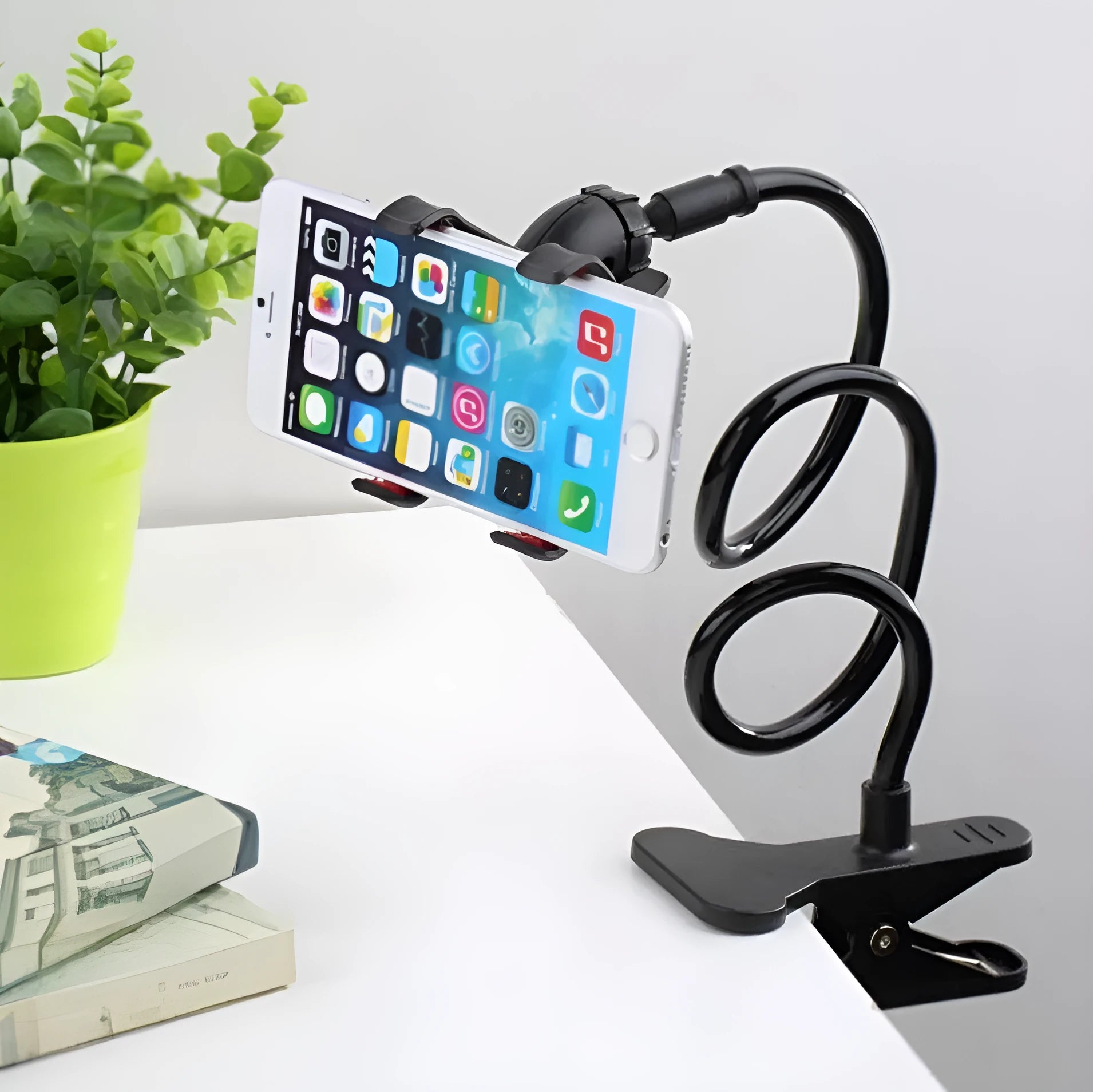 Black flexible arm phone holder with V-clip for smartphones on bed frame